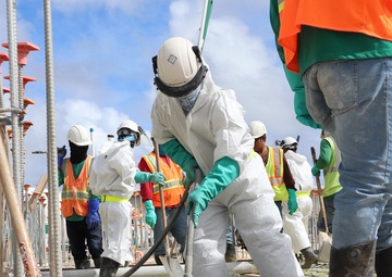 Construction Workers Vibrate a Fresh Pour of Concrete on Camp Blaz