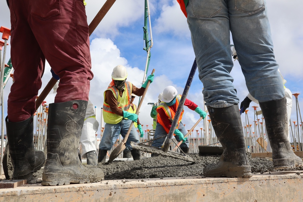 Construction Workers Smooth A Fresh Concrete Pour