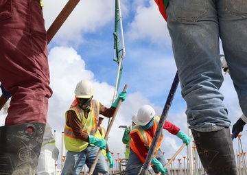 Construction Workers Smooth A Fresh Concrete Pour