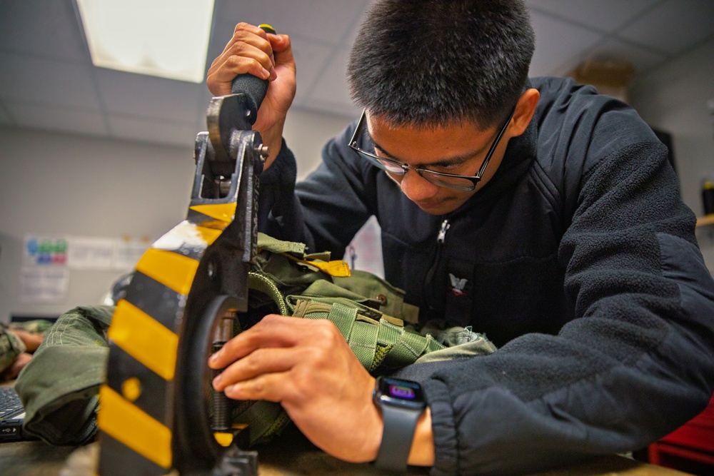VX-1 Sailor conducts maintenance on aircrew equipment