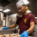 USS Mitscher (DDG 57) Sailor prepares food in ships galley