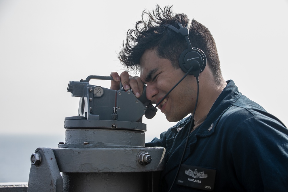USS Mitscher (DDG 57) Sailor uses alidade on bridge wing