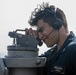 USS Mitscher (DDG 57) Sailor uses alidade on bridge wing
