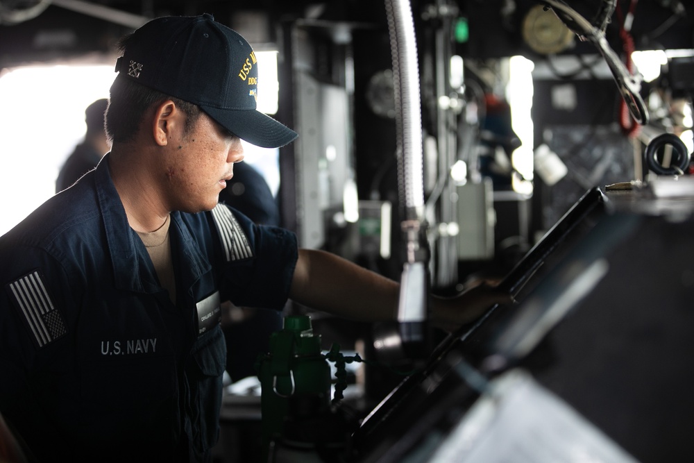 USS Mitscher (DDG 57) mans helm on the bridge