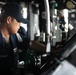 USS Mitscher (DDG 57) mans helm on the bridge