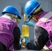 USS Mitscher (DDG 57) Sailors collect fuel sample during RAS