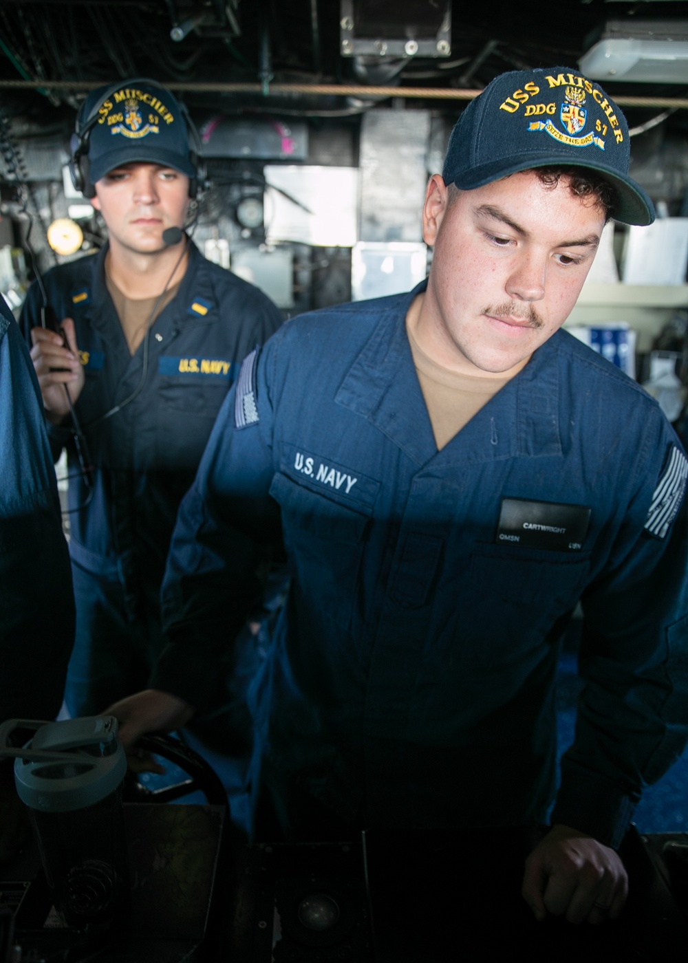 USS Mitscher (DDG 57) Sailor mans helm in ship bridge