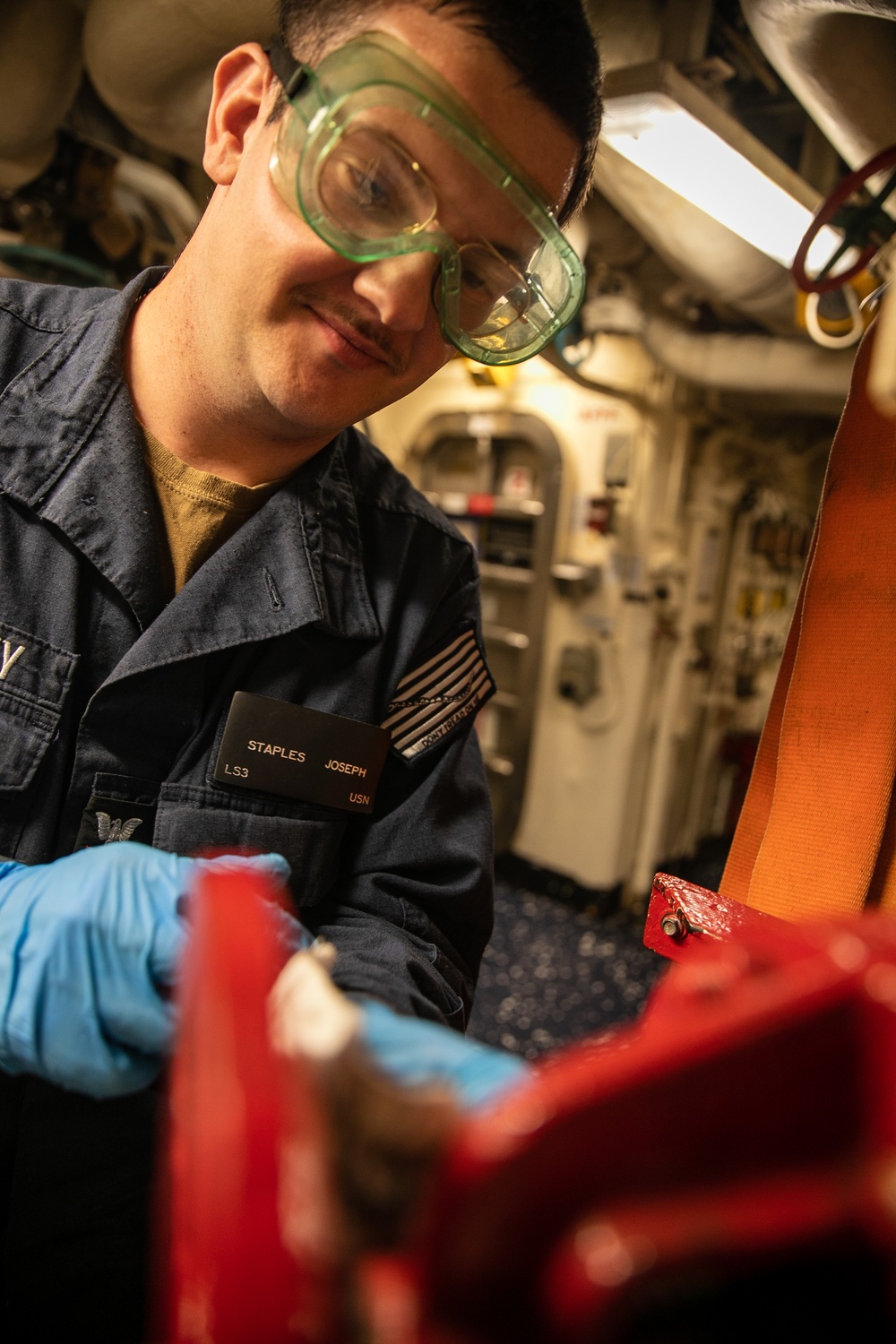 USS Mitscher (DDG 57) Sailor conduct firehose maintenance