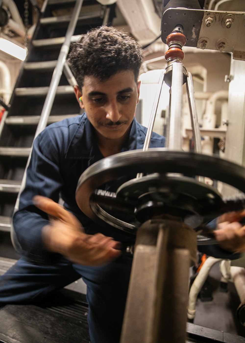 USS Mitscher (DDG 57) Sailor turns overboard discharge valve