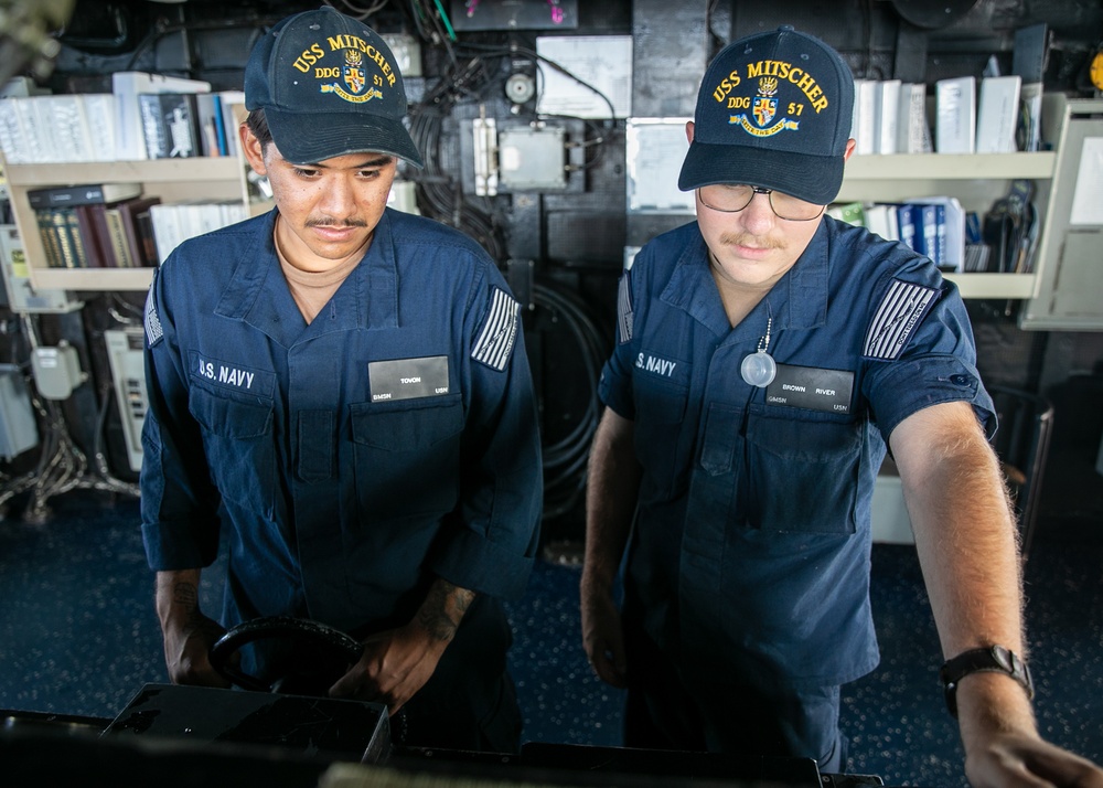 USS Mitscher (DDG 57) Sailors man ships helm