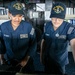 USS Mitscher (DDG 57) Sailors man ships helm