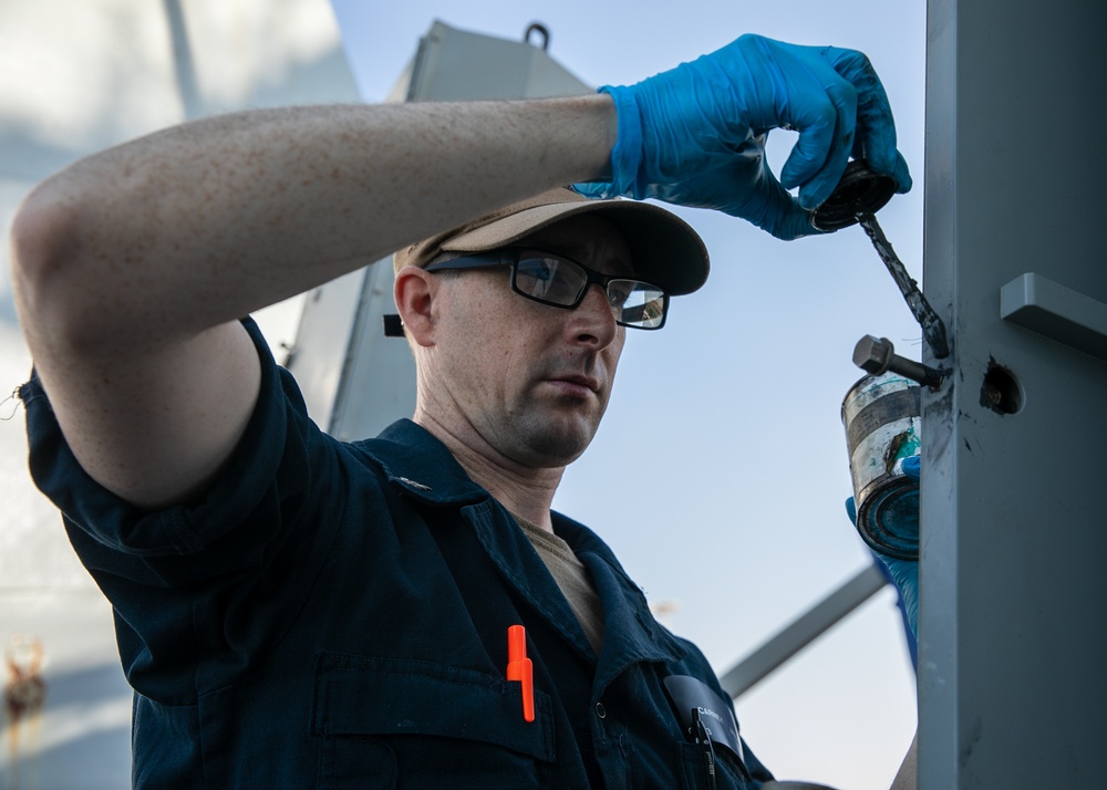 USS Mitscher (DDG 57) Sailor conducts maintenance on NULKA launching system