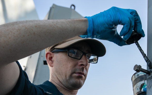 USS Mitscher (DDG 57) Sailor conducts maintenance on NULKA launching system