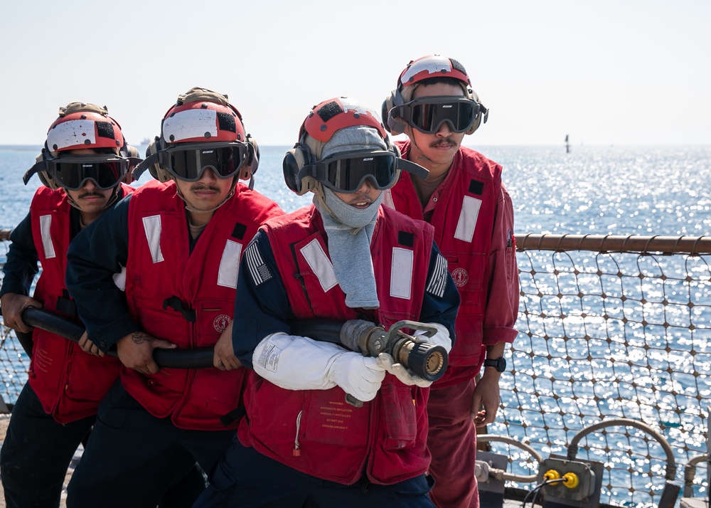 USS Mitscher (DDG 57) Sailors conduct flight deck firefighting drill