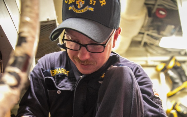USS Mitscher (DDG 57) Sailor inspects deck socket