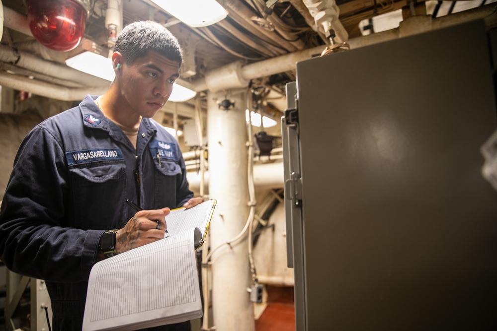USS Mitscher (DDG 57) Sailor takes readings in engine room