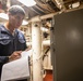 USS Mitscher (DDG 57) Sailor takes readings in engine room