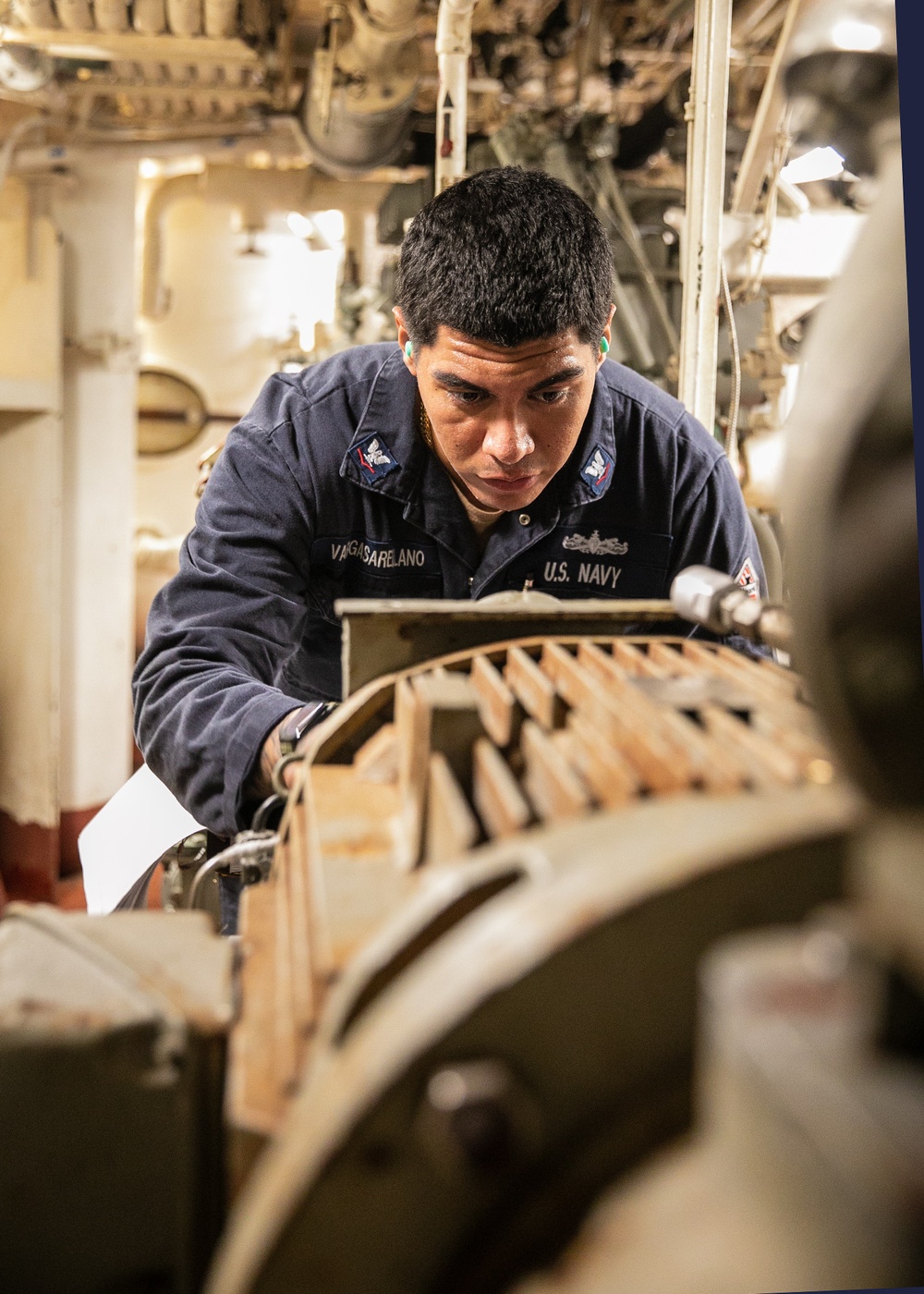USS Mitscher (DDG 57) Sailor takes readings in engine room