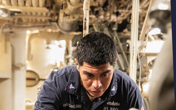 USS Mitscher (DDG 57) Sailor takes readings in engine room