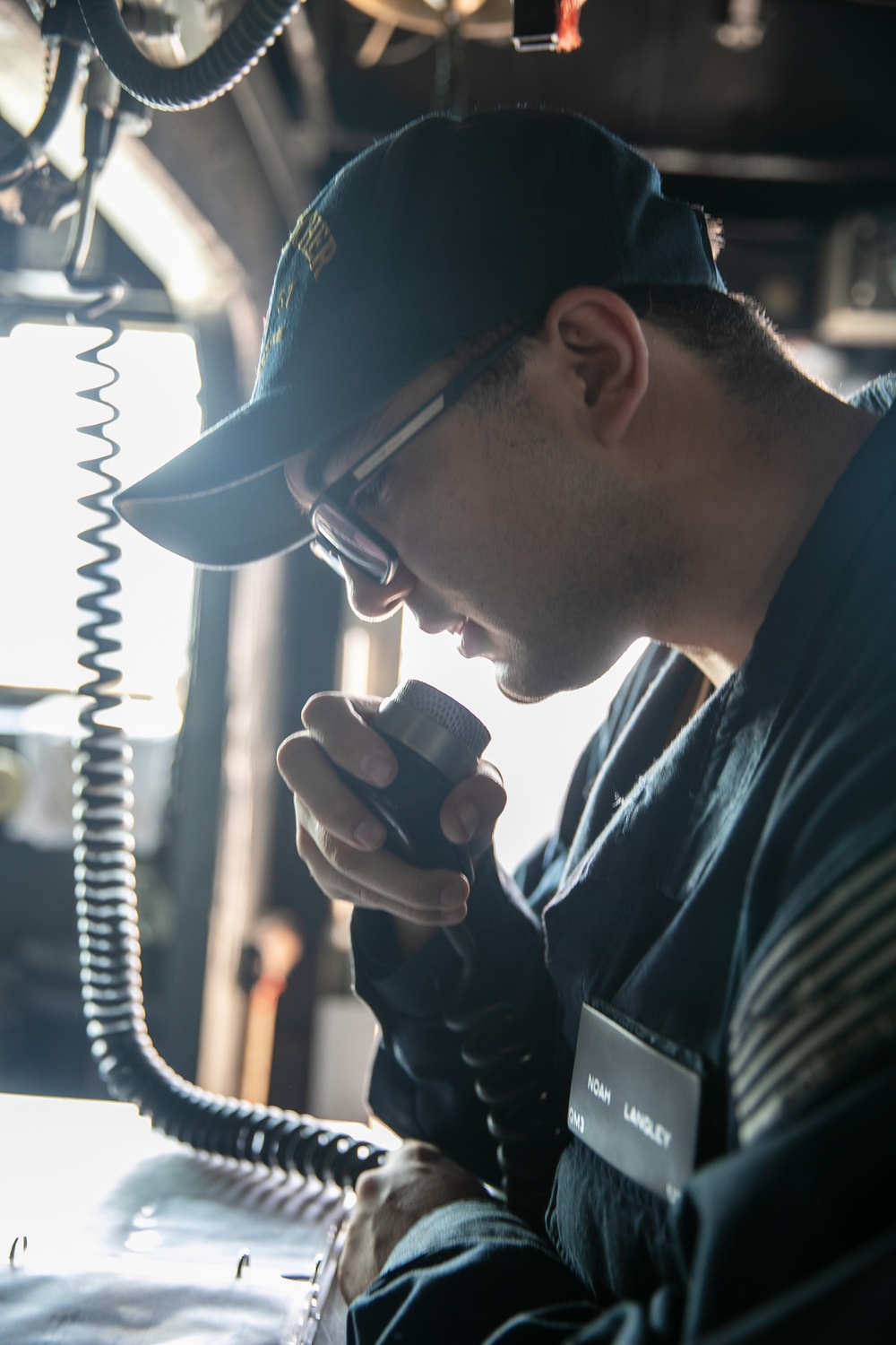 USS Mitscher (DDG 57) Sailor makes announcement on 1MC