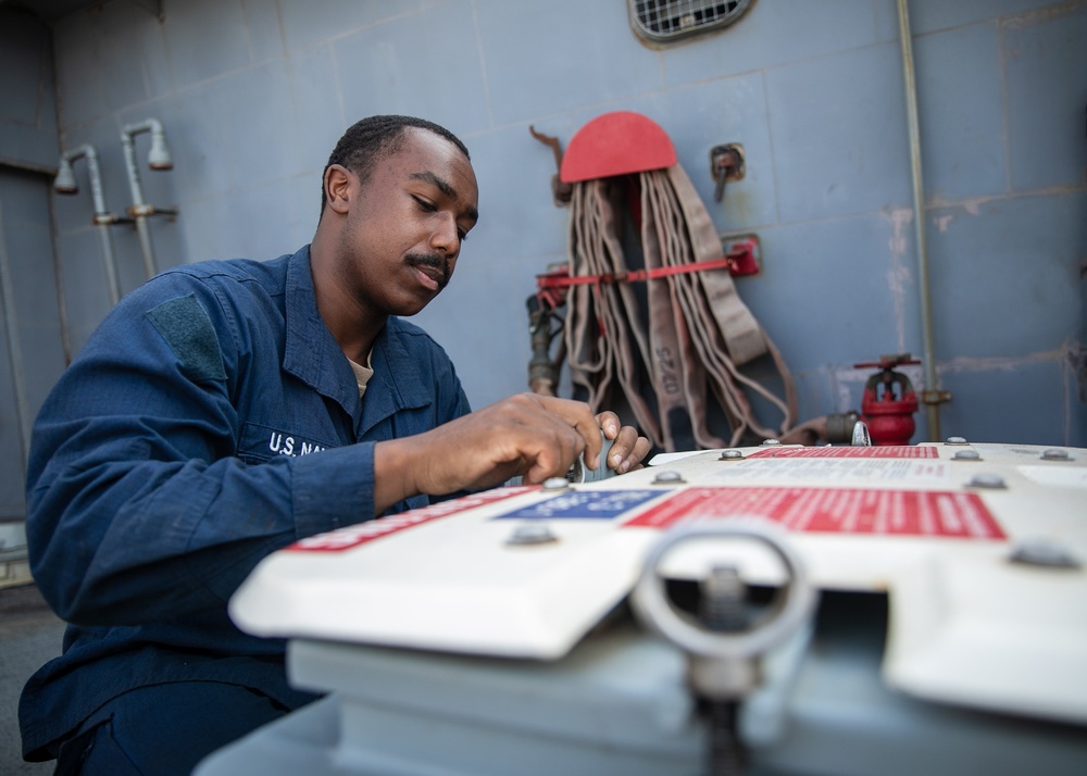 USS Mitscher (DDG 57) Sailor secures ammunition storage unit
