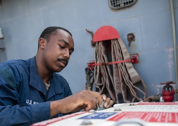USS Mitscher (DDG 57) Sailor secures ammunition storage unit