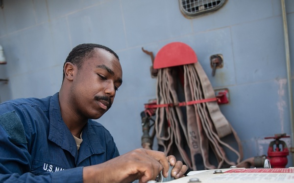 USS Mitscher (DDG 57) Sailor secures ammunition storage unit