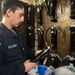 USS Mitscher (DDG 57) Sailor inspects HAZMAT in storage locker