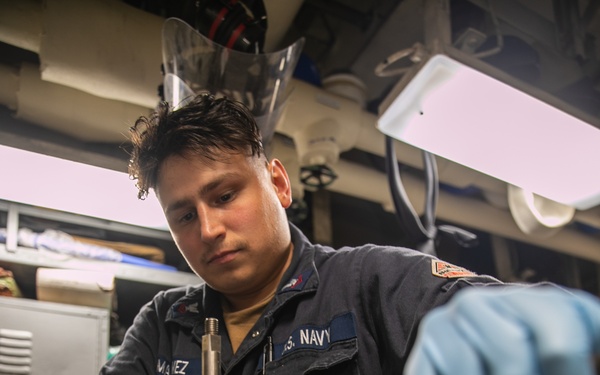 USS Mitscher (DDG 57) Sailor conducts maintenance on valve
