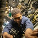USS Mitscher (DDG 57) Sailor secures fuse panel