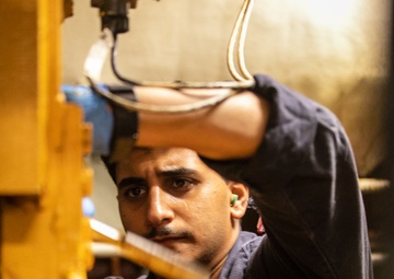 USS Mitscher (DDG 57) Sailor conducts maintenance in engine room