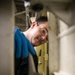 USS Mitscher (DDG 57) Sailor conducts hatch maintenance