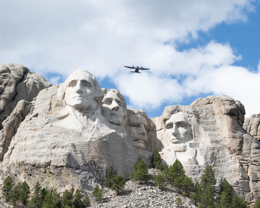 U.S. Coast Guard C-27J Spartan flies over Mount Rushmore National Memorial
