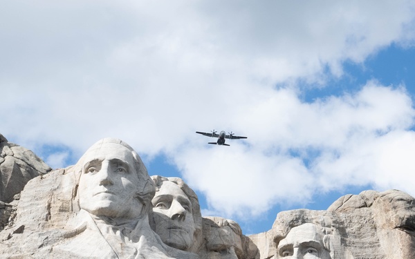U.S. Coast Guard C-27J Spartan flies over Mount Rushmore National Memorial