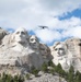 U.S. Coast Guard C-27J Spartan flies over Mount Rushmore National Memorial