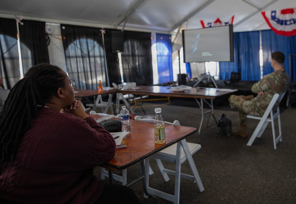 Service Member and civilians watch documentary on Revolutionary War