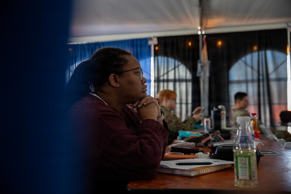 Service Member and civilians watch documentary on Revolutionary War