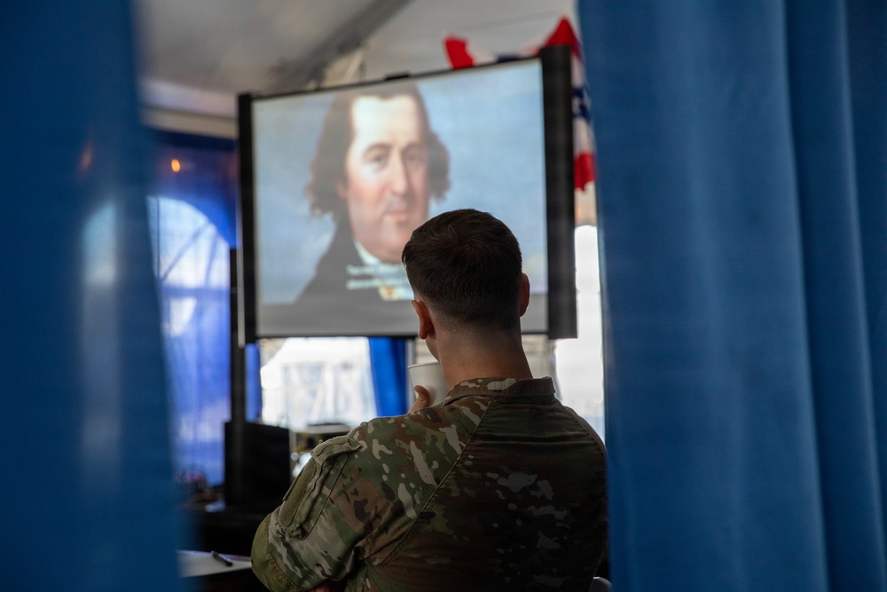 Service Member and civilians watch documentary on Revolutionary War