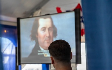 Service Member and civilians watch documentary on Revolutionary War