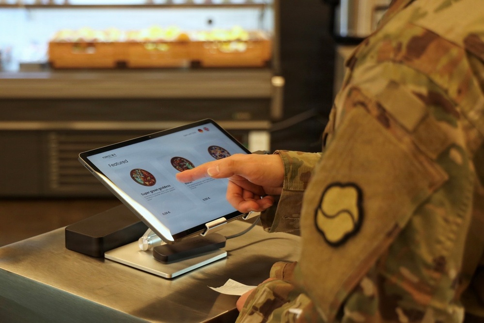 Soldier picks meal on terminal for the autonomous kitchen