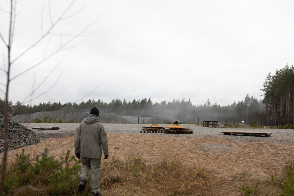 U.S. Marine explosive ordnance disposal technicians execute an experimental demolition range