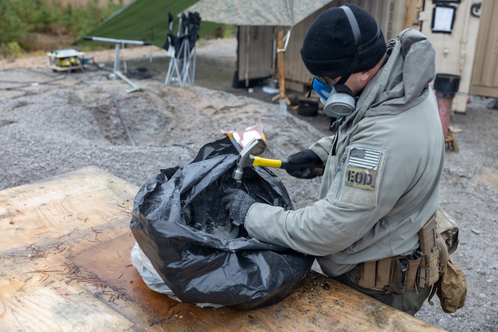 U.S. Marine explosive ordnance disposal technicians execute an experimental demolition range
