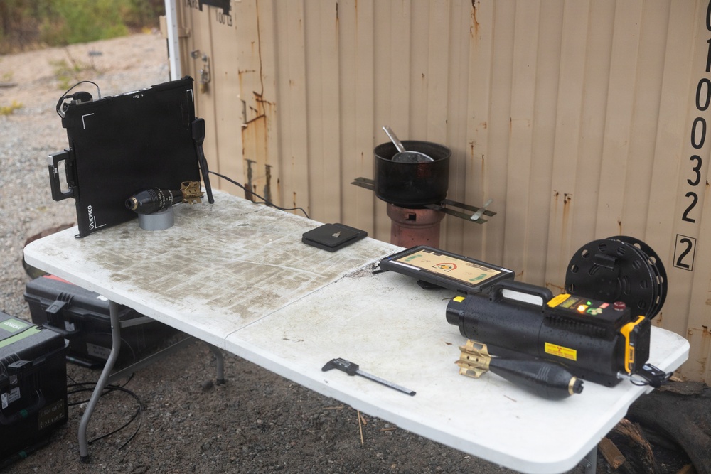 U.S. Marine explosive ordnance disposal technicians execute an experimental demolition range