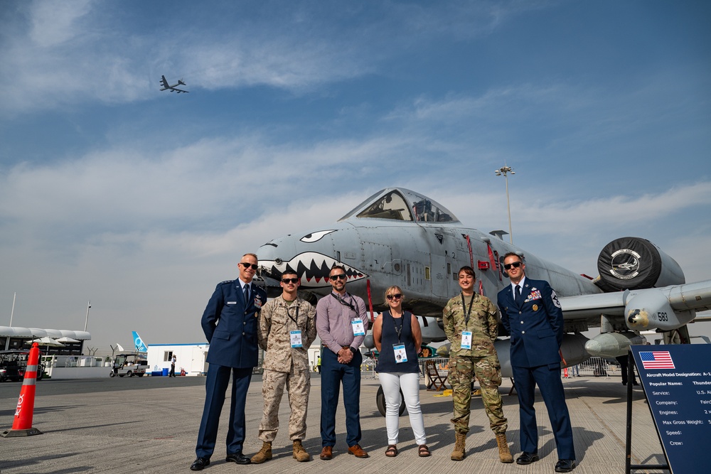 AFCENT commander stands with group in front of A-10, B-52