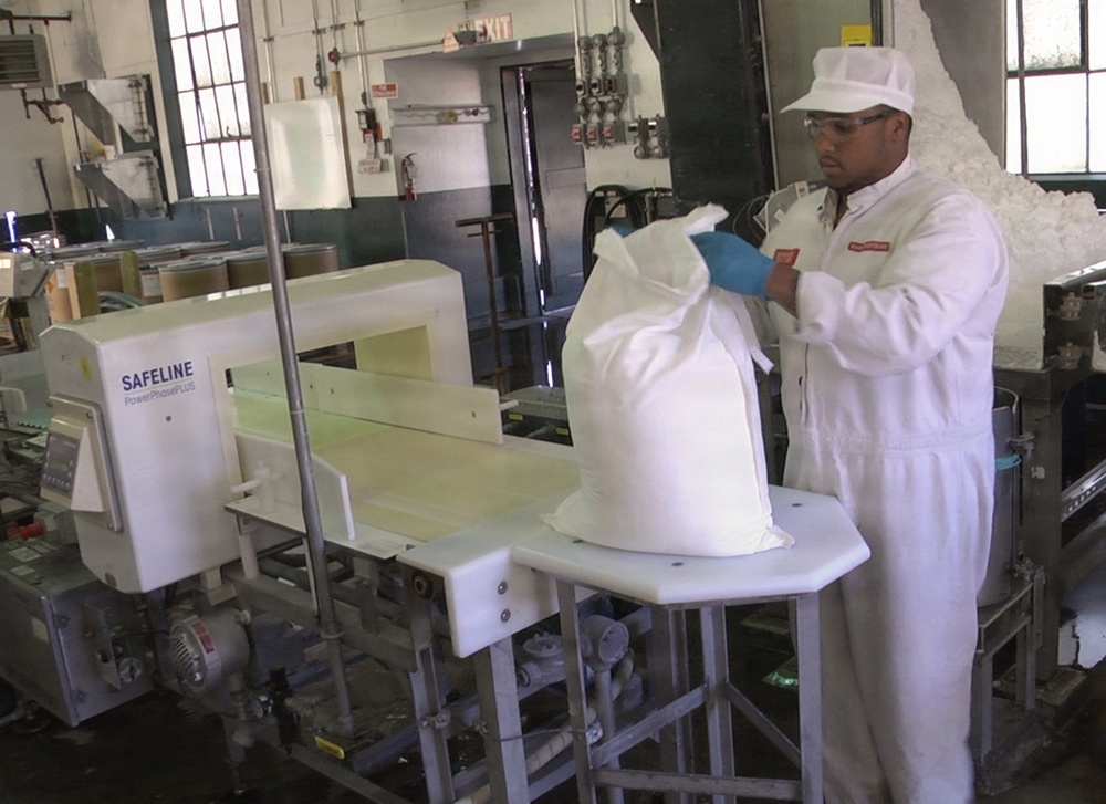 Worker bagging IMX at Holston Army Ammunition Plant