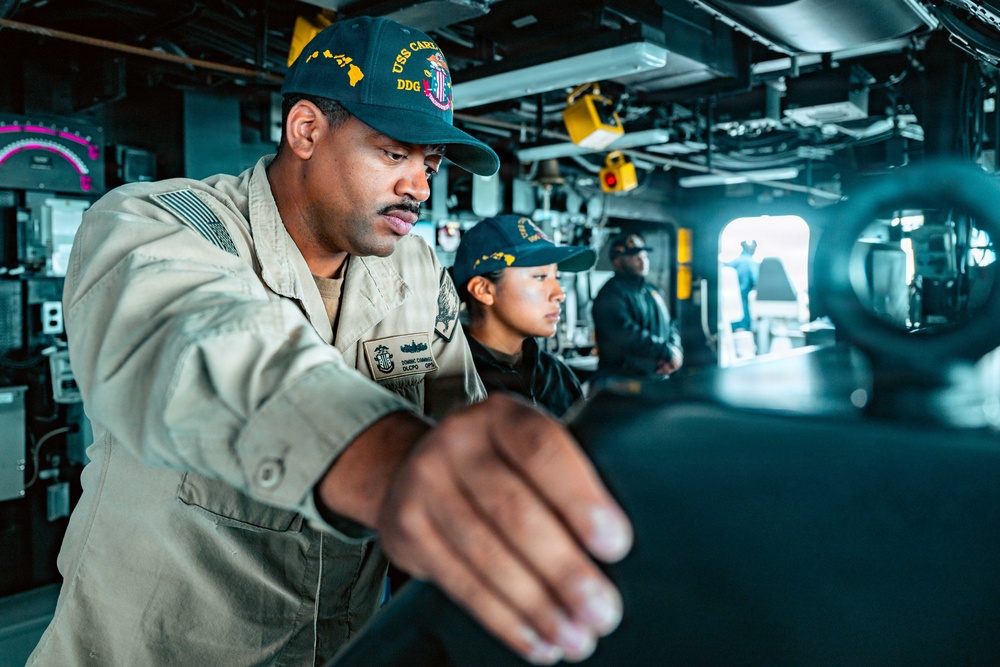 U.S. Navy Sailor Navigates on the Bridge