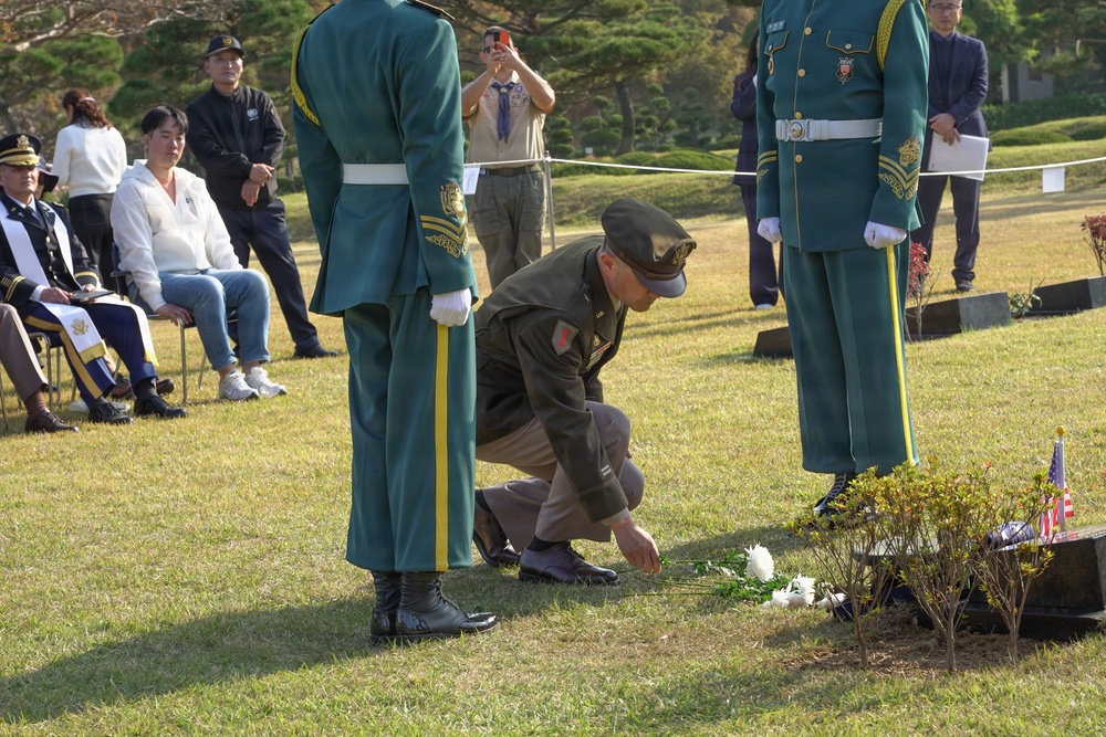 Placing flowers at the grave of a Korean War veteran