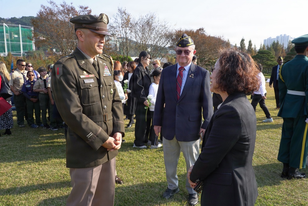 Memorial ceremony attendees converse