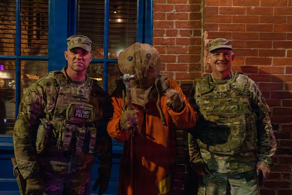 Joint Task Force Magnolia leadership takes pictures with the public on patrol on Halloween