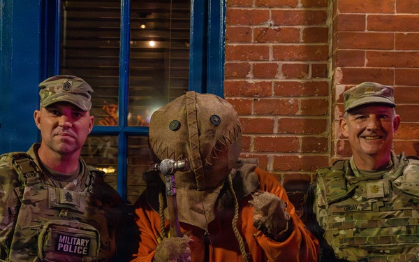 Joint Task Force Magnolia leadership takes pictures with the public on patrol on Halloween